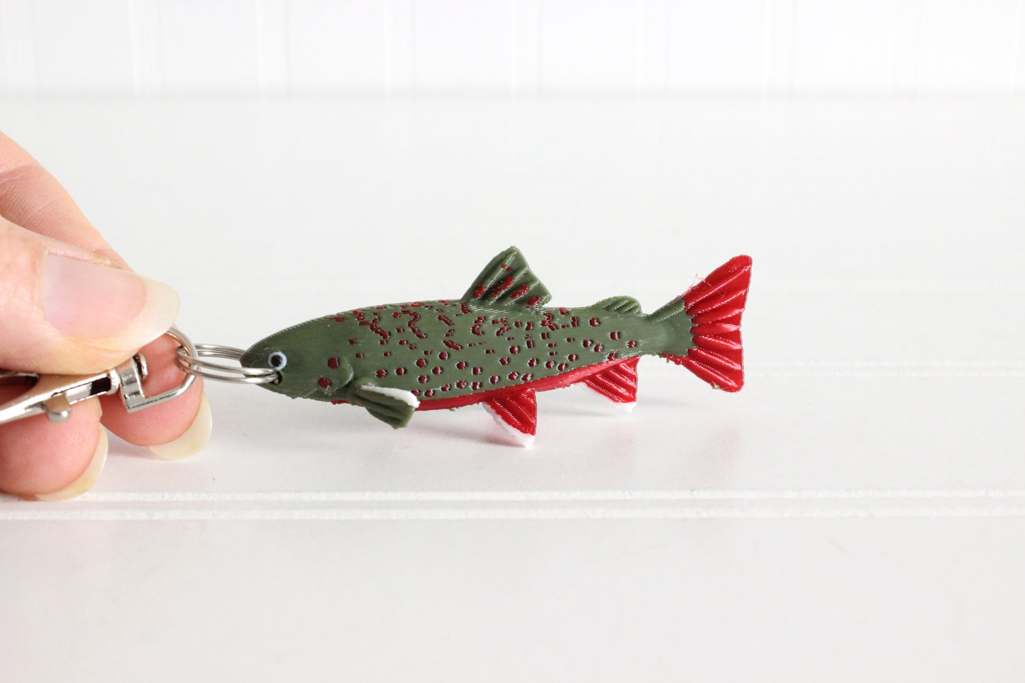 Alternate view of the 3D-printed brook trout with spotted markings keychain showing its sculpted details and segmented design.