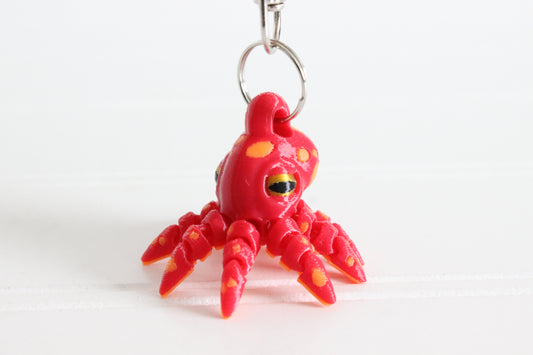 3D-printed octopus with curled tentacles keychain with a silver swivel quick-clip on a white background.