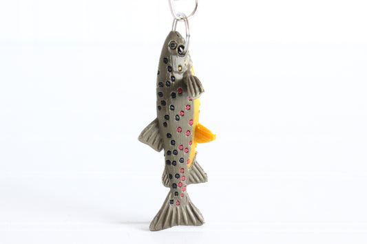 3D-printed brown trout with spotted markings keychain with a silver swivel quick-clip on a white background.
