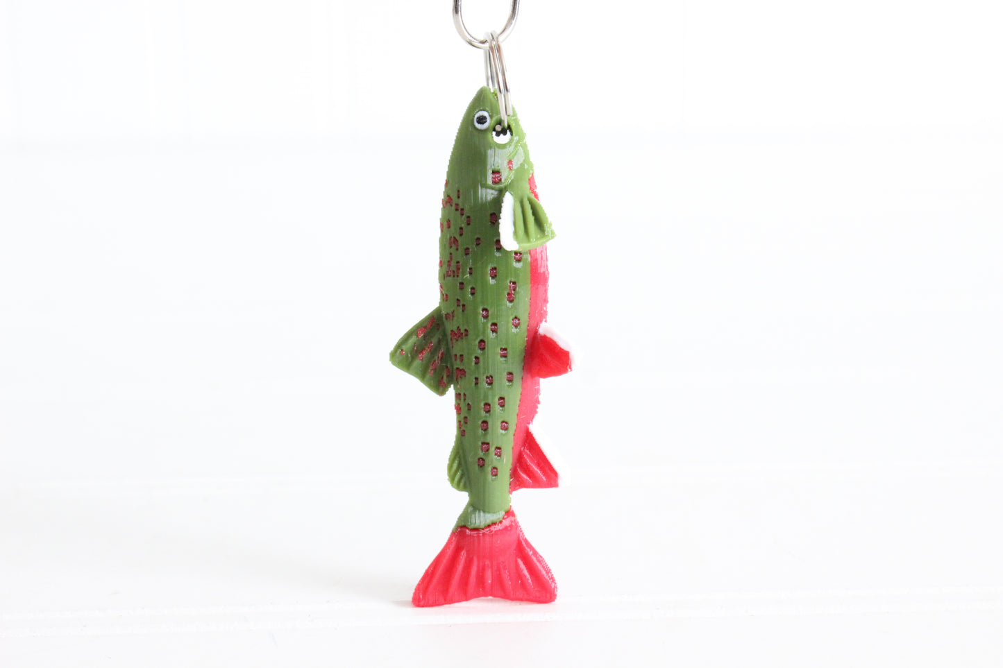 3D-printed brook trout with spotted markings keychain with a silver swivel quick-clip on a white background.