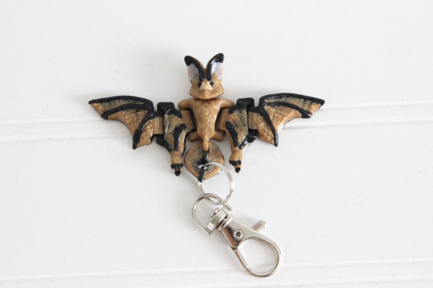 3D-printed bat keychain with spread wings and a silver key ring.