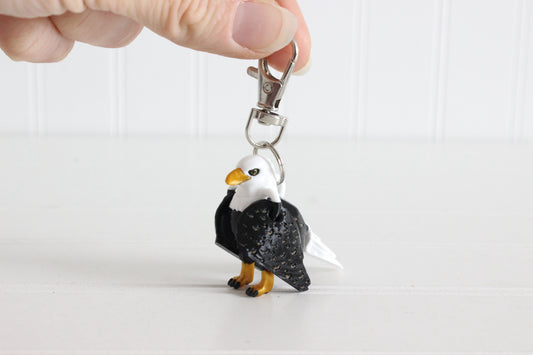 3D-printed brown-and-white eagle keychain with a silver swivel quick-clip on a white background.