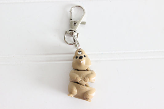 3D-printed brown groundhog keychain with a silver swivel quick-clip on a white background.
