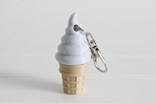 3D-printed cookies-and-cream soft-serve ice cream cone keychain with a metal key ring.