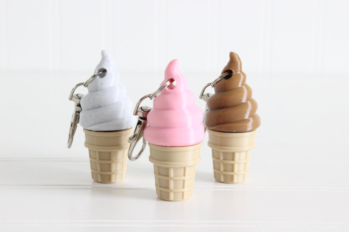Cookies and Cream, Strawberry, and Chocolate swirl ice cream cones