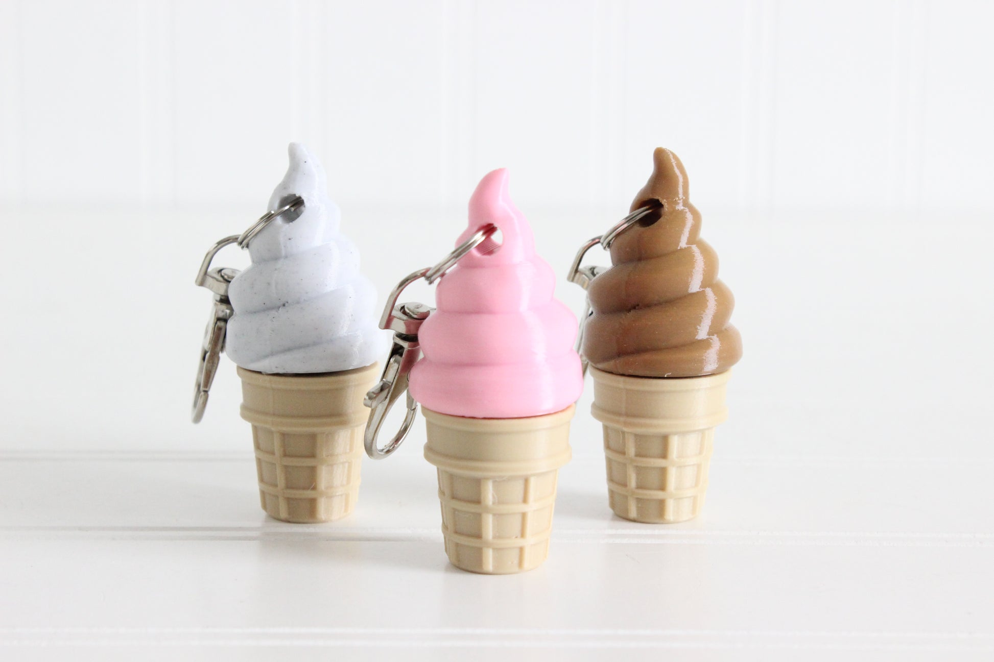 Cookies and Cream, Strawberry, and Chocolate swirl ice cream cones