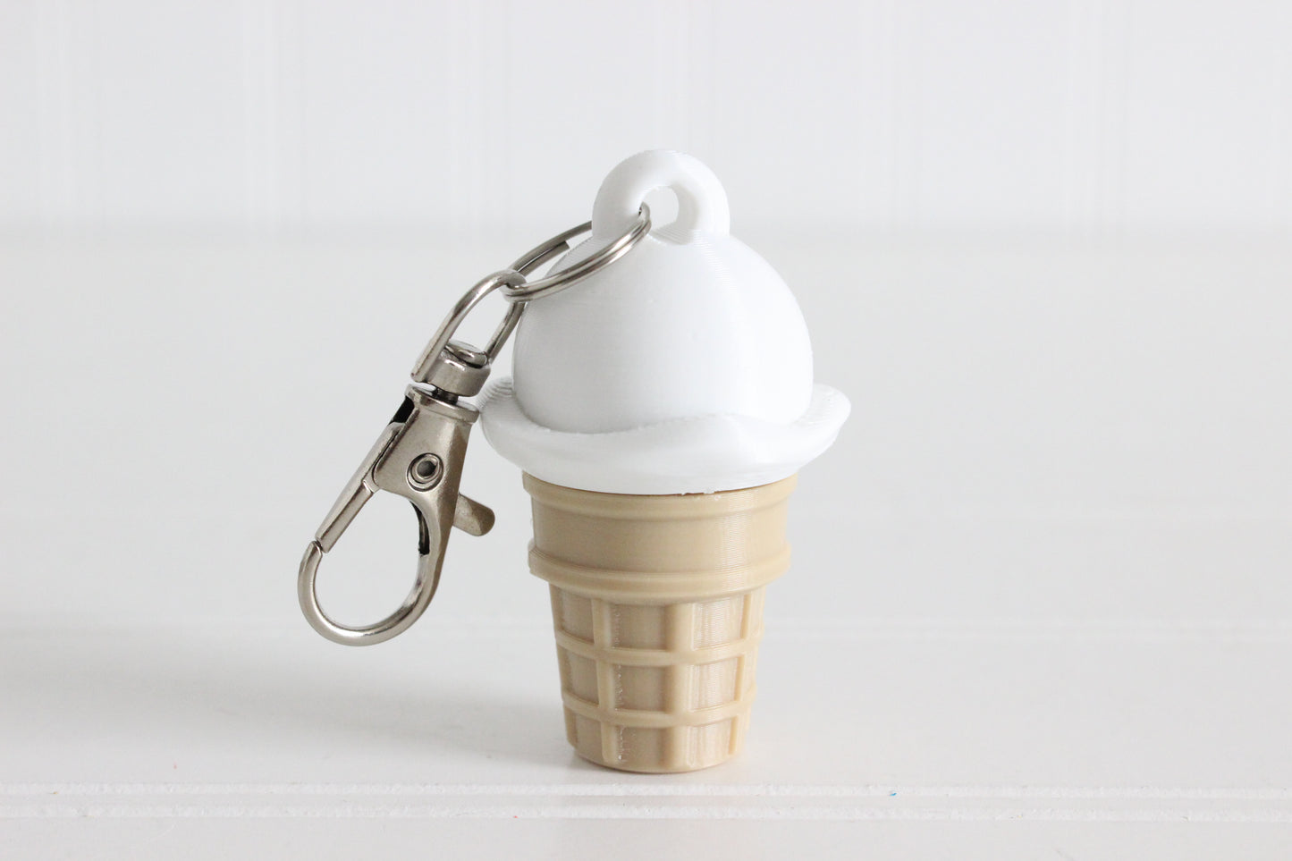 Vanilla ice cream cone 3D printed keychain with metal key ring.