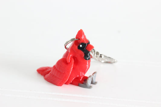 3D-printed red cardinal keychain with a silver swivel quick-clip on a white background.
