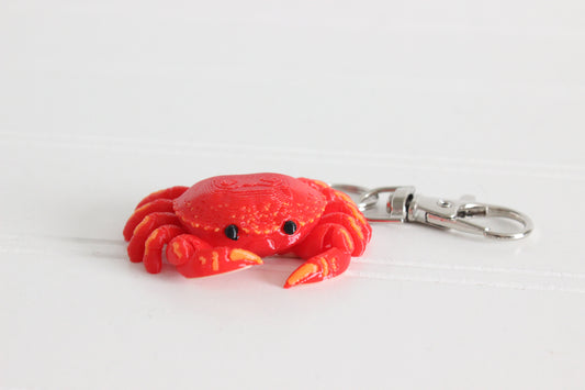 3D-printed red crab keychain with a silver swivel quick-clip on a white background.