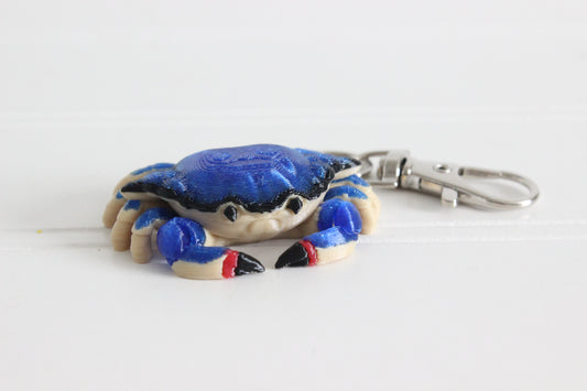 3D-printed blue crab keychain with a silver swivel quick-clip on a white background.