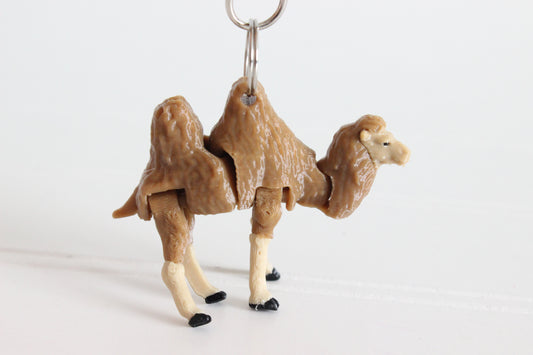 Articulated brown-and-cream camel keychain with textured fur and a silver swivel clip.