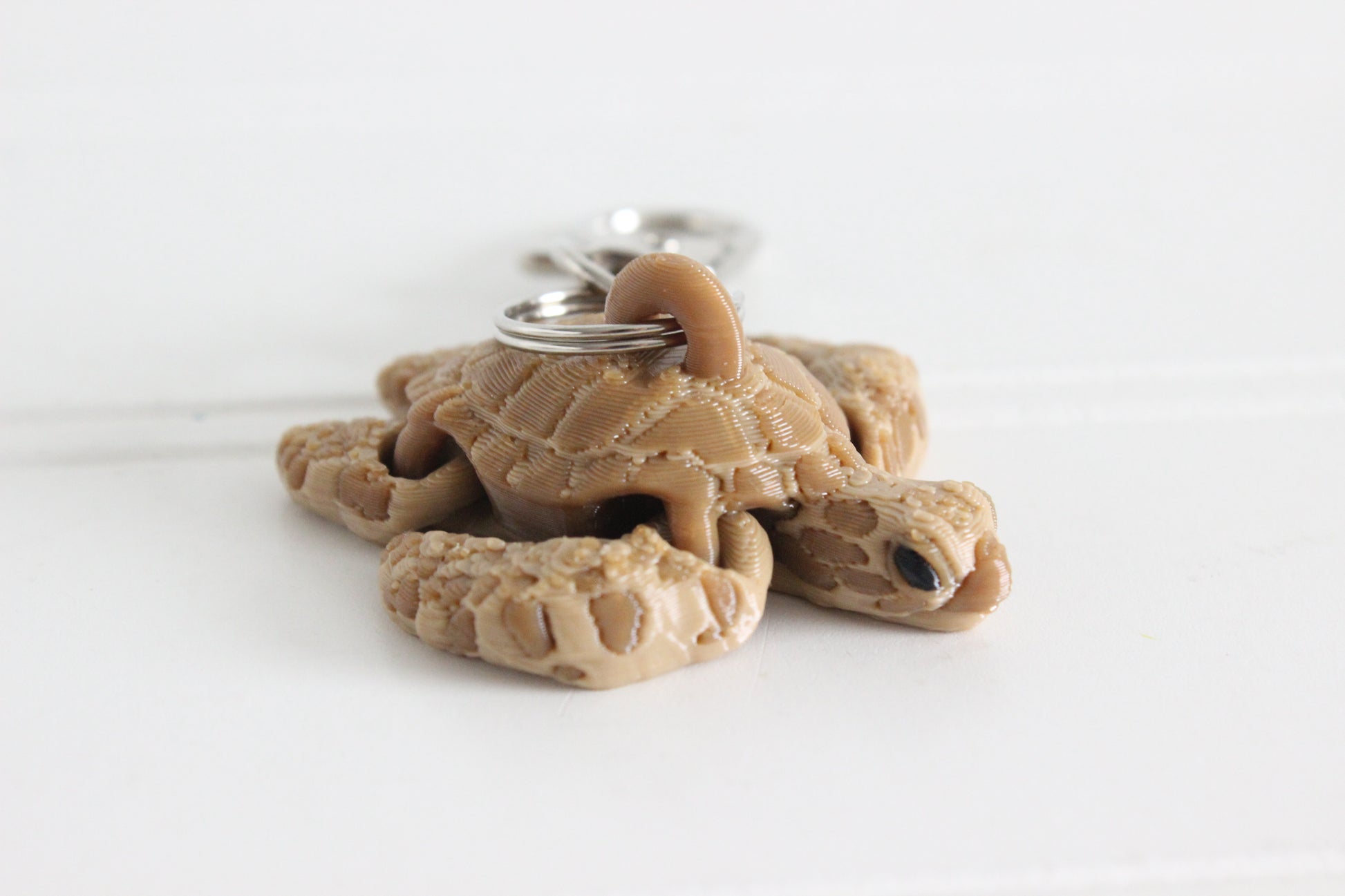 3D printed brown sea turtle keychain with silver key ring