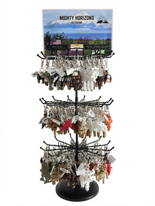 Mighty Horizons three-tier black tabletop display stand fully stocked with assorted 3D-printed animal keychains and a Northern display sign.